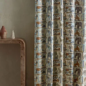 blue animal curtain with side table and vases