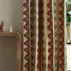 multicolour striped curtain with side table and vases