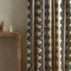 blue striped curtain with side table and vases