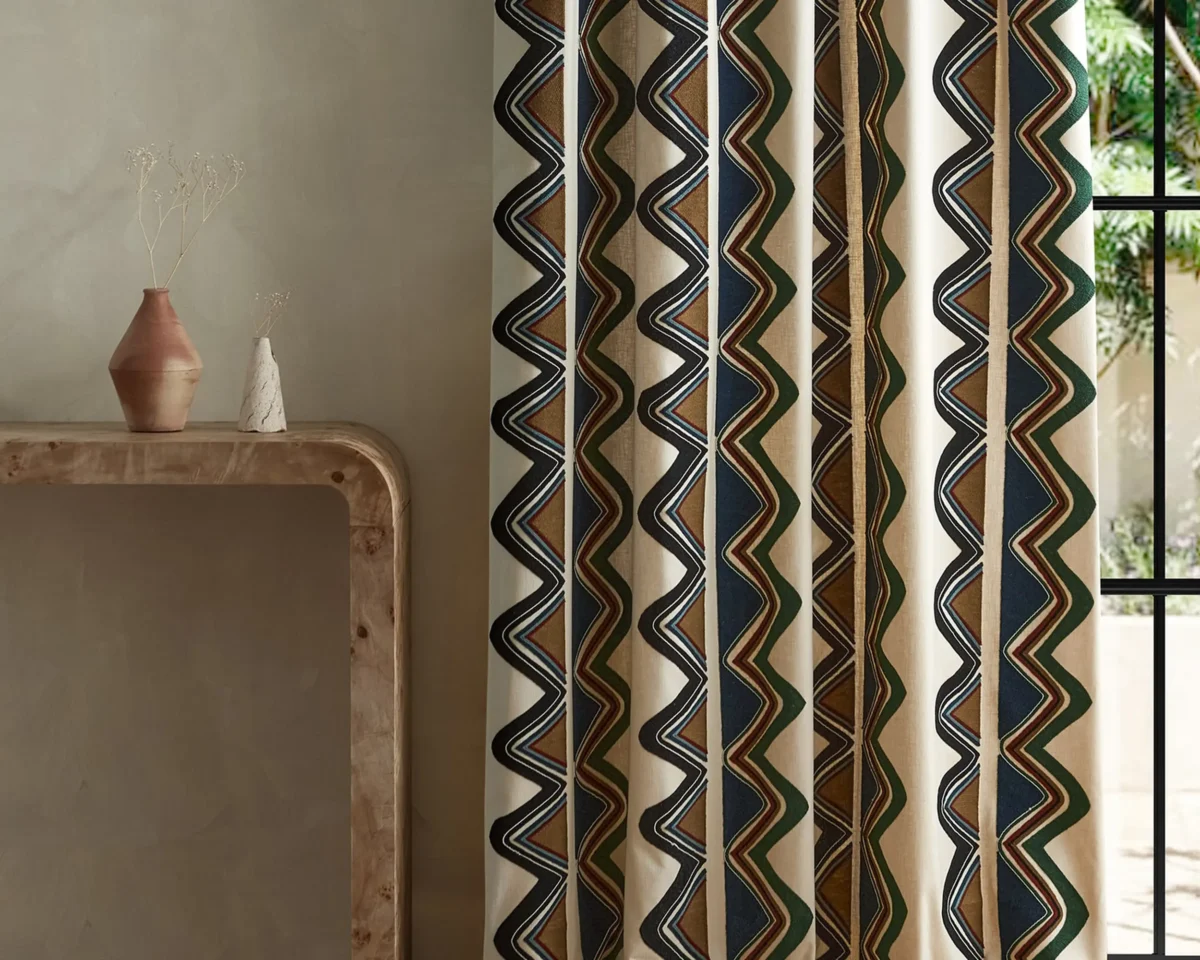 Kaleido Fabric - Moss / Onyx by blue striped curtain with side table and vases