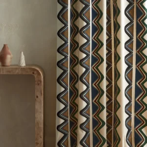 blue striped curtain with side table and vases