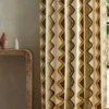 multicolour striped curtain with side table and vases