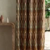 green geometric curtain with side table and vases