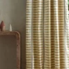 neutral striped curtain with side table and vases
