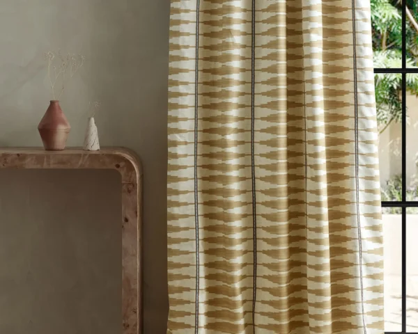 neutral striped curtain with side table and vases