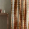 red striped curtain with side table and vases
