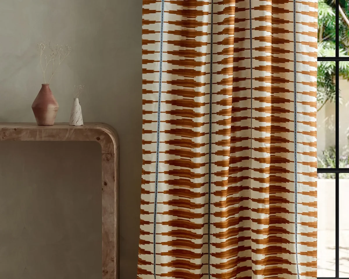 Cintilla Fabric - Spice / Adriatic by red striped curtain with side table and vases