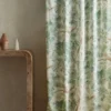 green botanical curtain with side table and vases