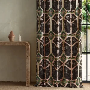 pink geometric curtain with side table and vases