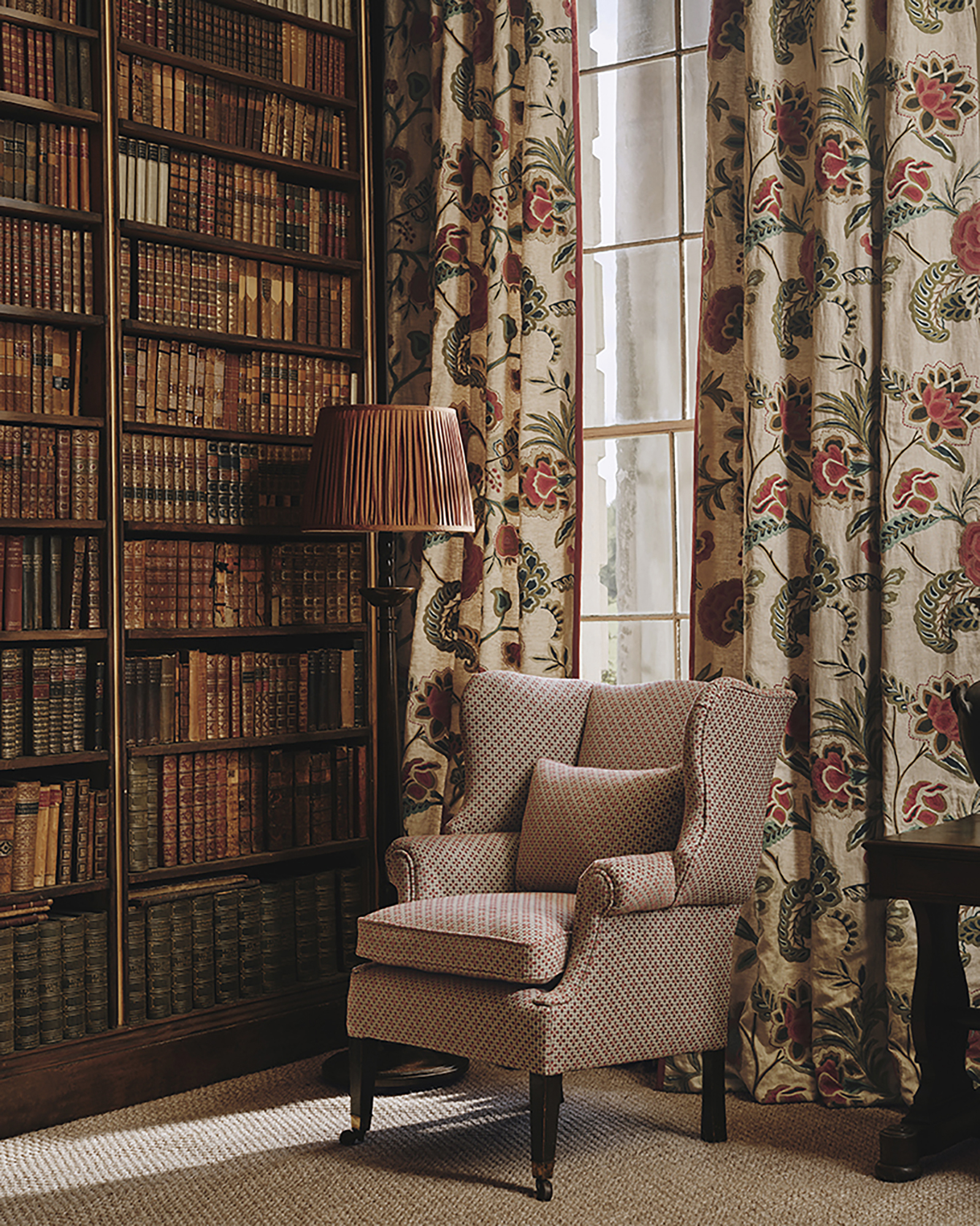 library with statement chair and floral floor length curtains