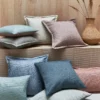 red plain cushion with sofa and vases