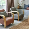red plain armchair with cushion and curtain