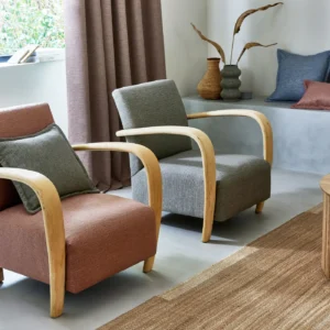 red plain armchair with cushion and curtain