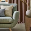 neutral plain sofa with curtain and cushion