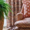 brown geometric armchair with cushion and curtain