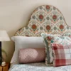 green botanical bed with cushion and lamps