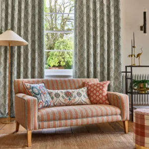 green striped sofa with curtain and cushion