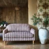 red striped sofa with plants and vases