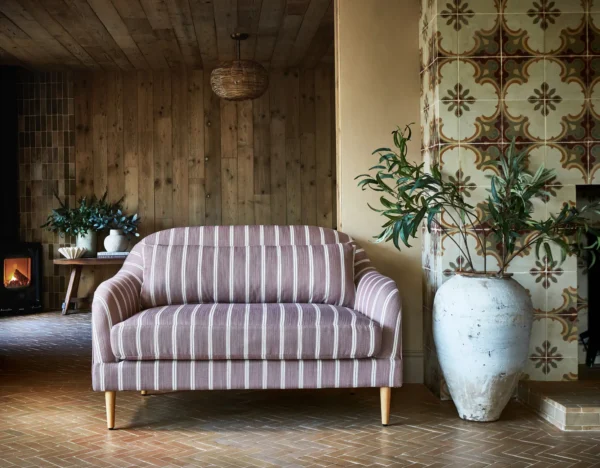 Georgia Fabric - Sunshine by red striped sofa with plants and vases