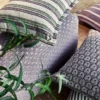 purple striped curtain with armchair and cushion