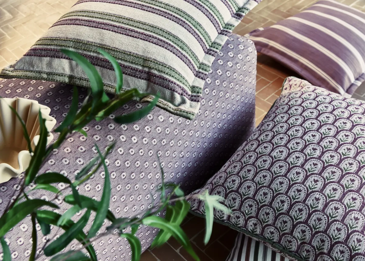 purple striped curtain with armchair and cushion