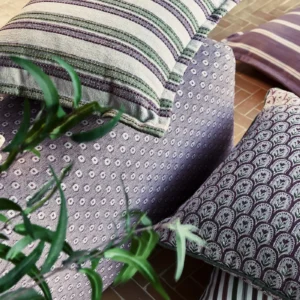 purple striped curtain with armchair and cushion