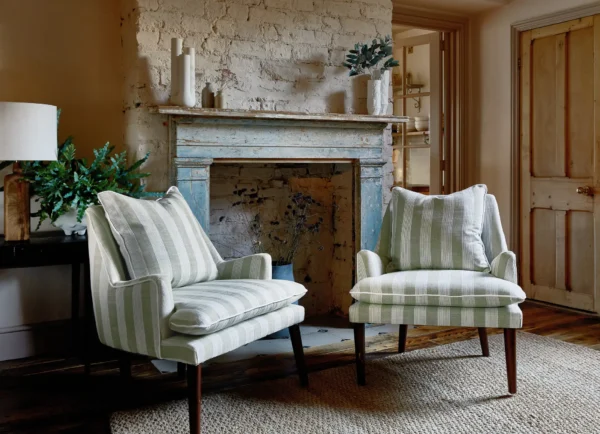 Antonia Fabric - Sienna by black-grey striped armchair with lamps and plants